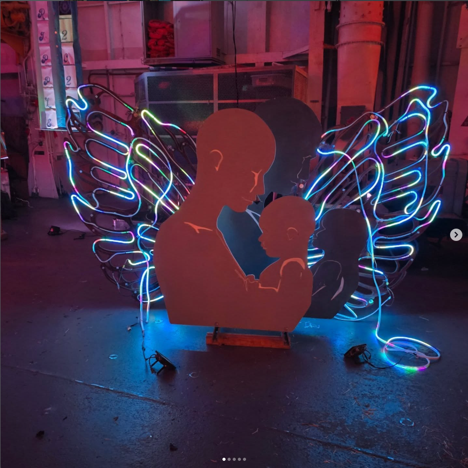 Neon angel sculpture with LED wings